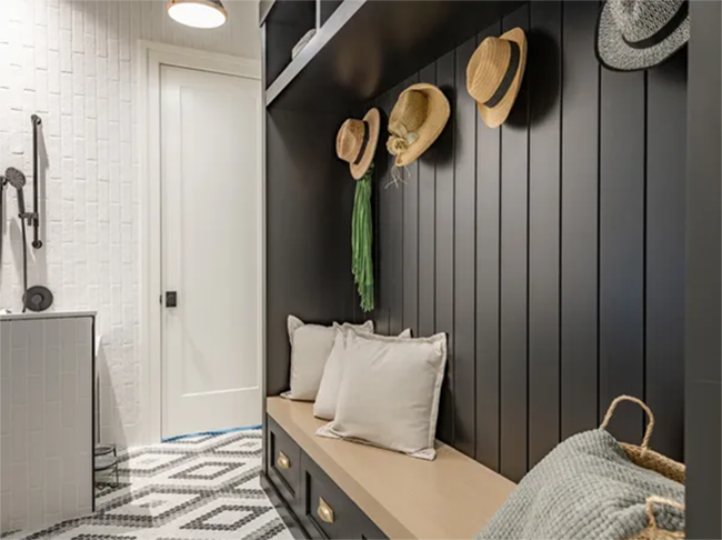 Custom mudroom with dark shiplap, built-in bench and storage